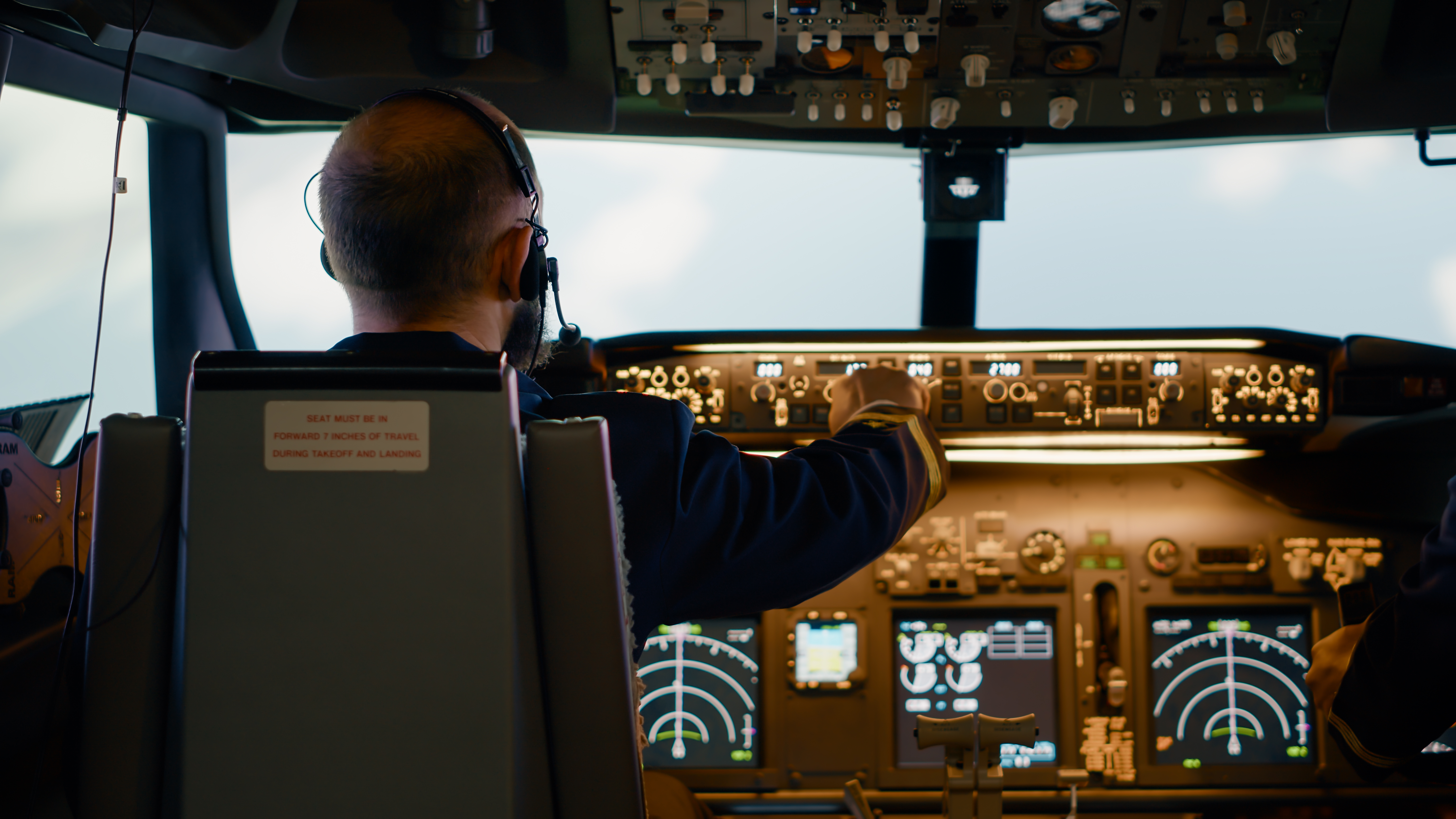 Student pilot walking toward a trainer aircraft at sunrise